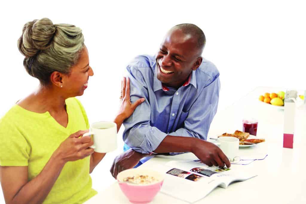 Couple Having Breakfast And Reading Magazine In Kitchen; Shutterstock ID 165823046; PO: redownload; Job: redownload; Client: redownload; Other: redownload
