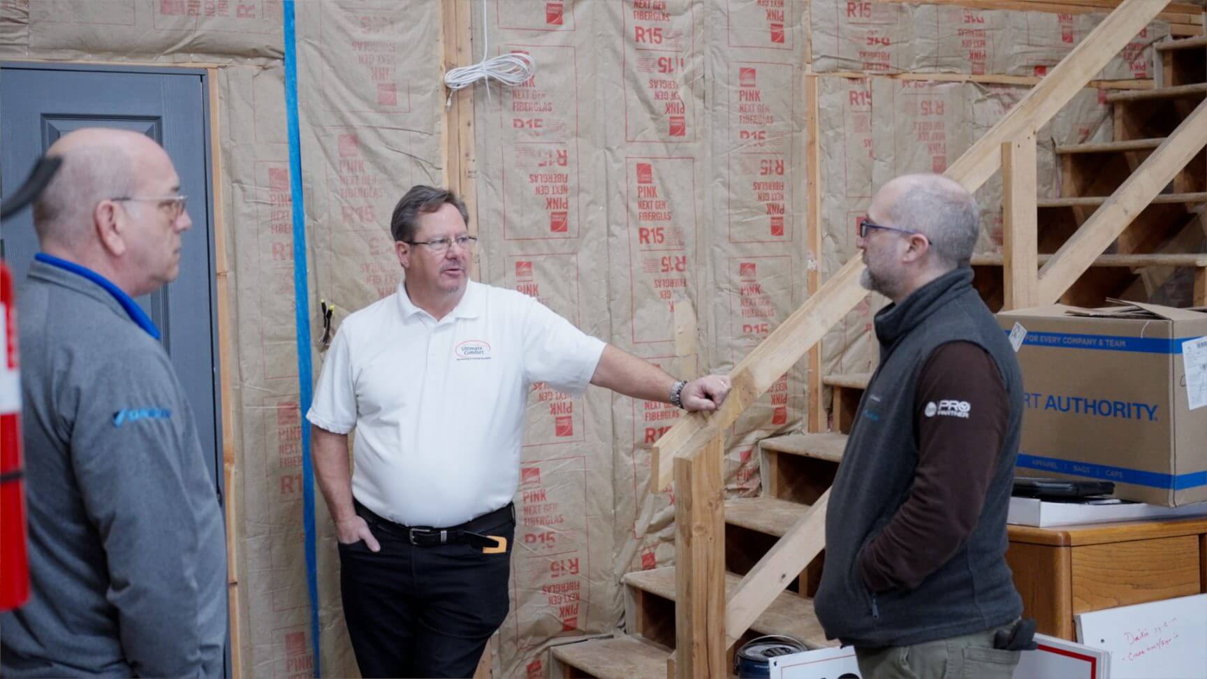Three men discussing in a construction site.
